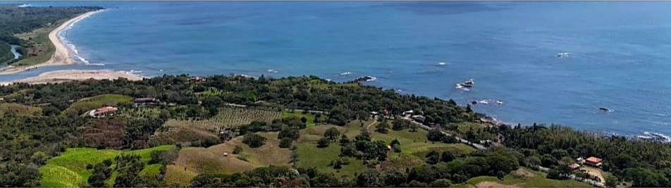 Wide coastal panorama looking along the shoreline from the OceanView hills