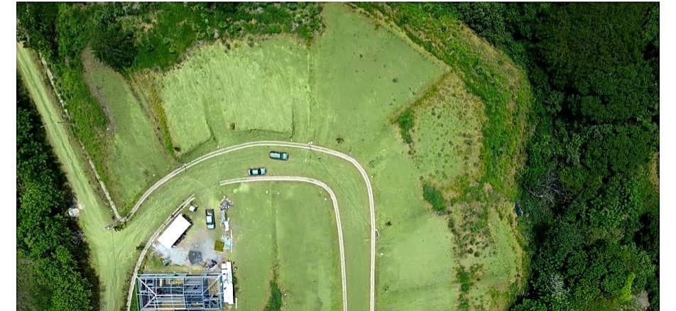 Aerial view of the completed road loop with a house under construction on one of the lots